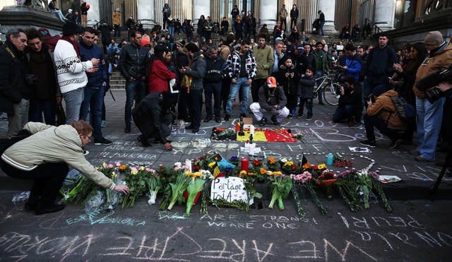 BRUSSELS, BELGIUM - MARCH 22: People leave tributes at the Place de la Bourse following today's attacks on March 22, 2016 in Brussels, Belgium. At least 31 people are thought to have been killed after Brussels airport and a Metro station were targeted by explosions. The attacks come just days after a key suspect in the Paris attacks, Salah Abdeslam, was captured in Brussels. (Photo by Carl Court/Getty Images)