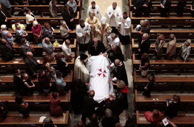 A pall is placed on the casket of Phyllis Schlafly, founder of the Eagle Forum, during her funeral Mass at the Cathedral Basilica of St. Louis on Saturday, Sept. 10, 2016. (Robert Cohen/St. Louis Post-Dispatch via AP, Pool)